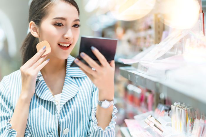Woman testing makeup products from a trusted OEM cosmetics manufacturer