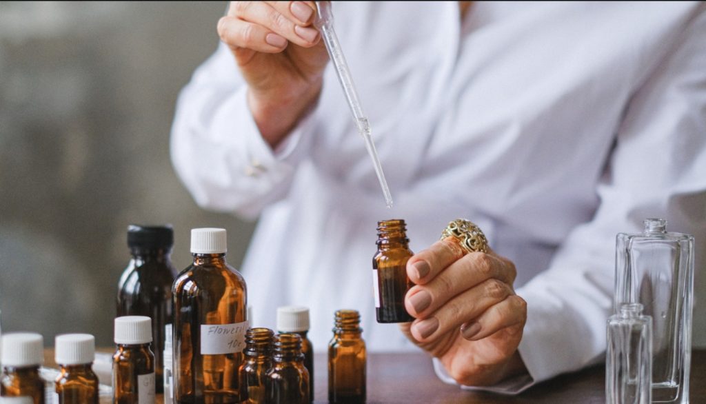 A perfumer at work during the fragrance formulation process in a manufacturing lab.